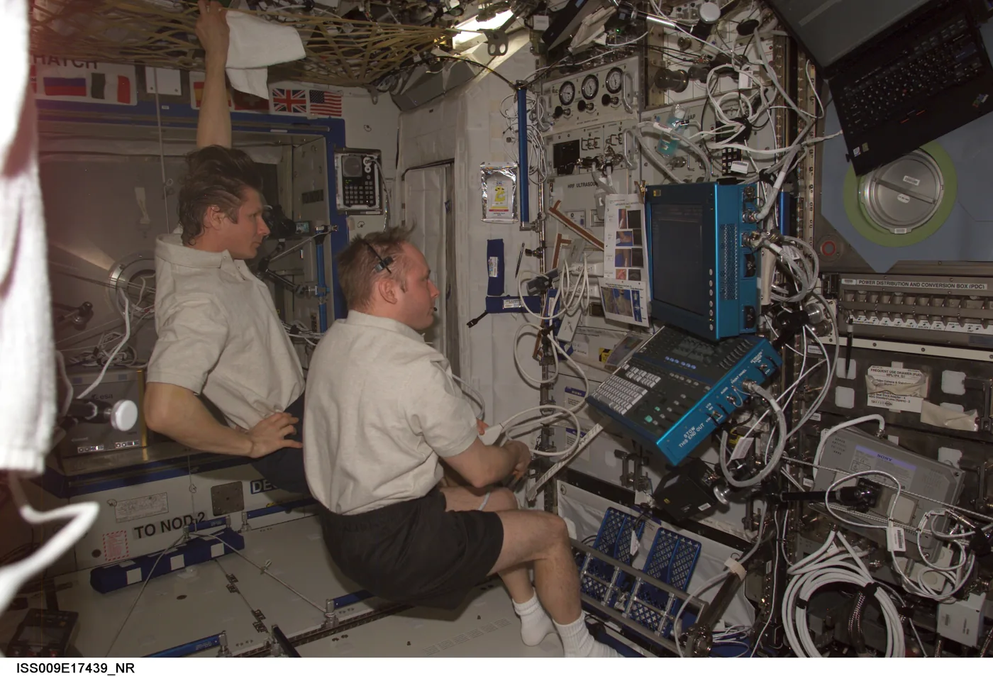 Astronaut Mike Fincke performs an ADUM ultrasound scan on cosmonaut Gennady Padalka in the Destiny laboratory of the International Space Station