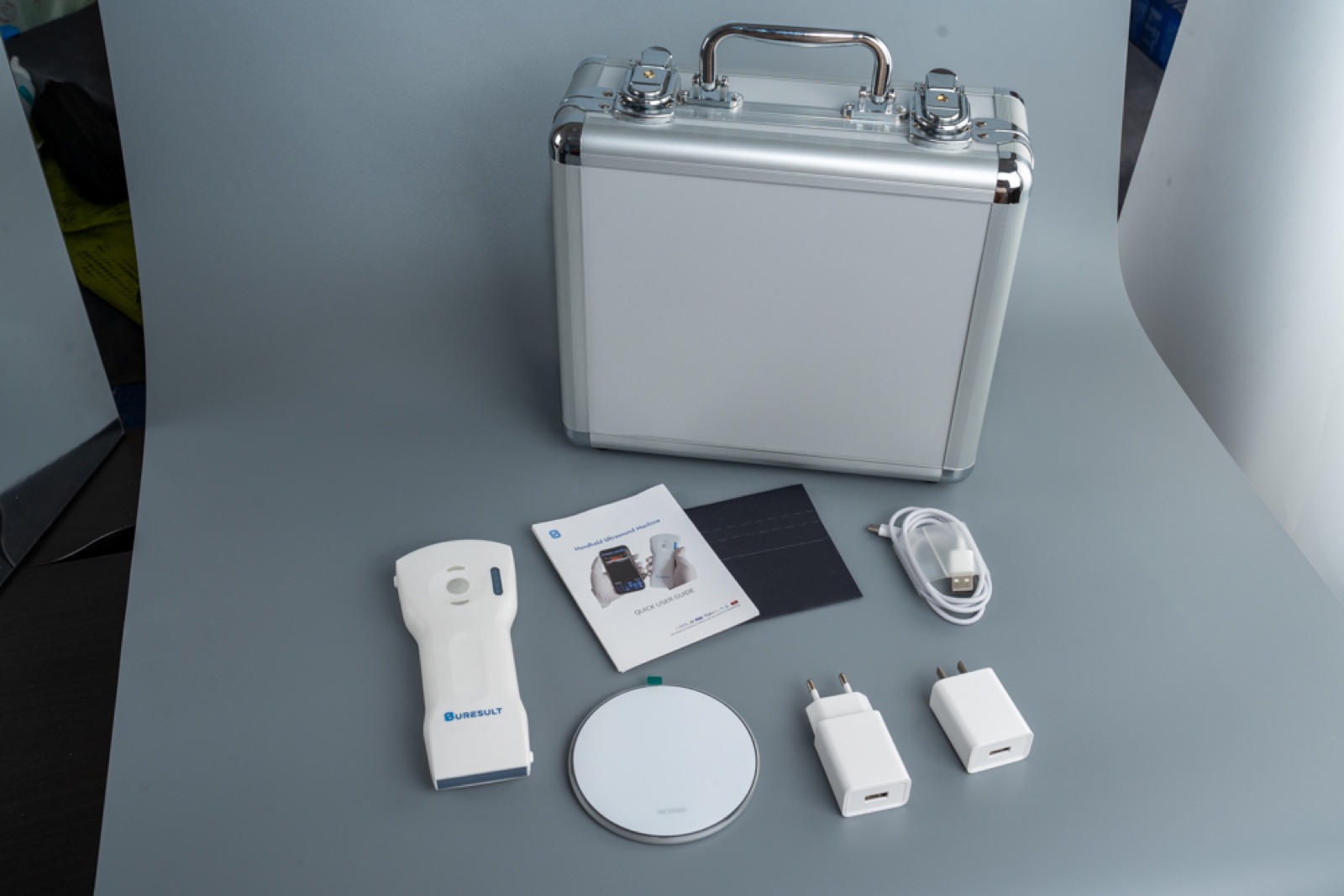 What's in the box: Suresult handheld ultrasound probe, aluminum case, manual, wireless charging pad, EU and US chargers, USB cable